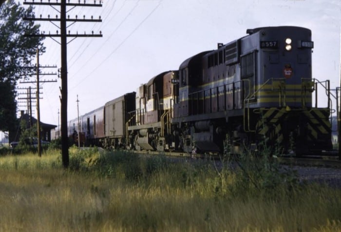 35 mm color slide of CPR 8557 and train departing Locust Hill, Ontario, on a summer evening