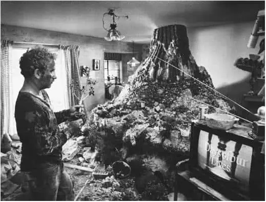 Man in living room with huge mountain model taking over room - Richard Dreyfus in Close Encounters of the Third Kind